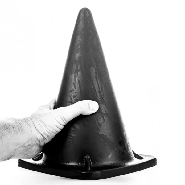 A hand holds the side of the All Black Cone Dildo, showcased in a high-contrast, black-and-white photograph against a plain white background.