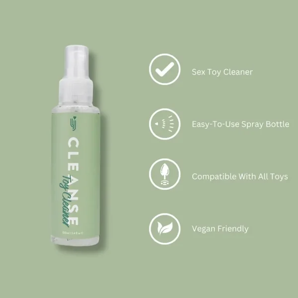 A spray bottle labeled "Loving Joy Cleanse Toy Cleaner" sits on a green background. Text highlights its features: sex toy cleaner, easy-to-use spray, suitable for all toys, and vegan friendly.