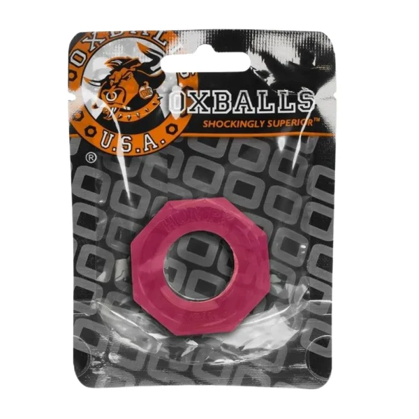 The Oxballs Humpballs Cock Ring, in pink and octagonal shape, comes in a clear plastic wrapper with a black and orange "OXBALLS U.S.A." label featuring a bull logo; the background displays a repeating "O" pattern.