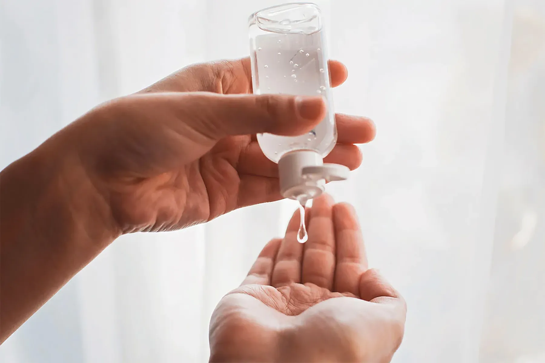 squirting lube from bottle onto hand