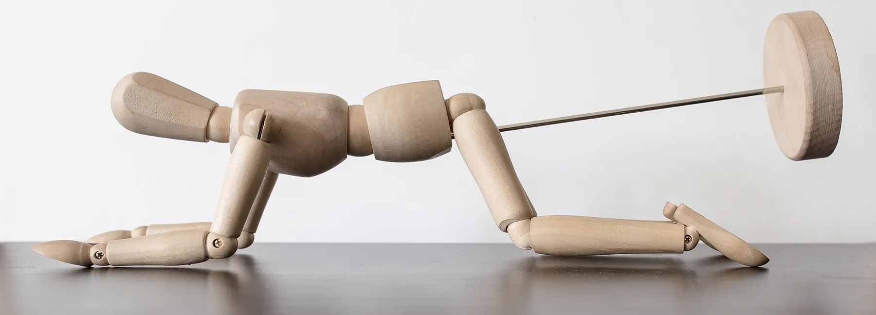 wooden stick man bent over in doggy style position