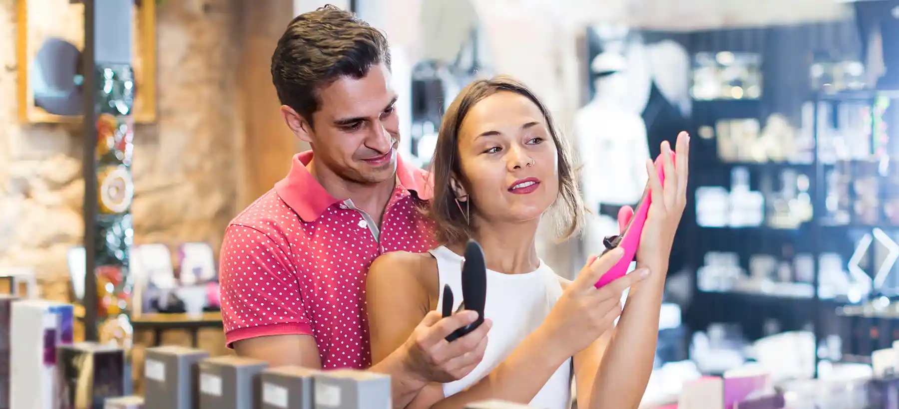couple choosing sex toy in a sex shop