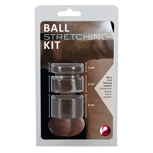 Packaging of the Ball Stretching Kit, which includes three black rings labelled with their respective diameters of 1 cm, 2 cm, and 3 cm. The kit promises an extension of up to 6 cm. The background features a partially visible image of a person's body.