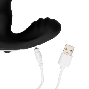 The Ouch Beaded Vibrating Prostate Massager with Remote Control, a black prostate toy, features a curved ergonomic design with a textured protruding section and connects to a white USB charging cable.