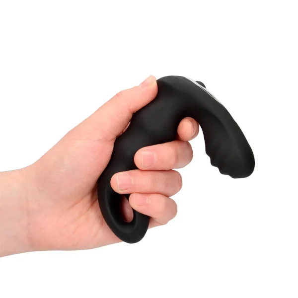 A hand holds the Ouch Beaded Vibrating Prostate Massager With Remote Control, featuring a black, curved ergonomic design, textured surface for comfort against a plain white background.