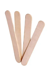 Four wooden tongue depressors arranged in a fanned-out formation against a white background.