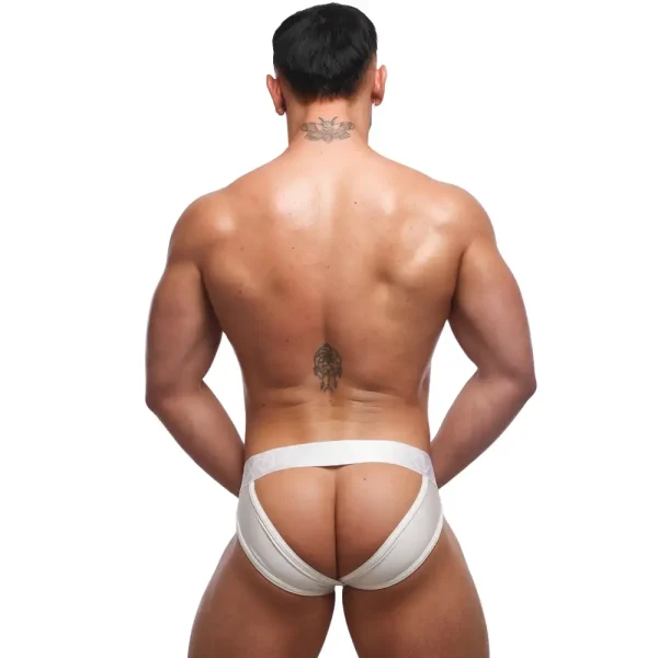 A muscular man with short dark hair stands showing his backside against a plain white background, showing his tattoos while wearing the Sukrew White Shimmer U-Style V Brief.