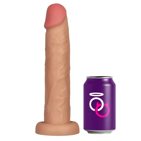 The Power Basics 10 Inch Realistic Vibrating Dildo, featuring a lifelike flesh tone and pronounced head, stands upright beside a purple soda can with Saints and Sinners logo for size comparison.