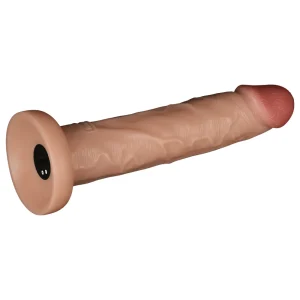 The Power Basics 10 Inch Realistic Vibrating Dildo features a flesh-toned silicone design with a flared base and detailed veining for lifelike texture. It is led on its side showing the base of the dildo, which features magnetic charging port.