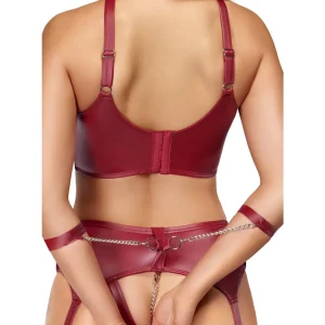 Close up of the back of a person modelling the Cottelli Bondage Wireless Bra & Crotchless Suspender Thong Set in red faux leather with metal chain accents, displaying the back with arms restrained by matching red straps attached to the lingerie.