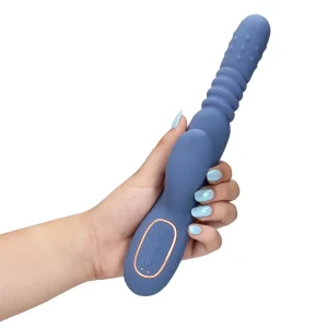 A hand with light blue painted nails holds the Loveline Warming Rotating Beads and Thrusting Rabbit Vibrator, a blue silicone sex toy featuring ribbed and textured sections and a control panel near the base.