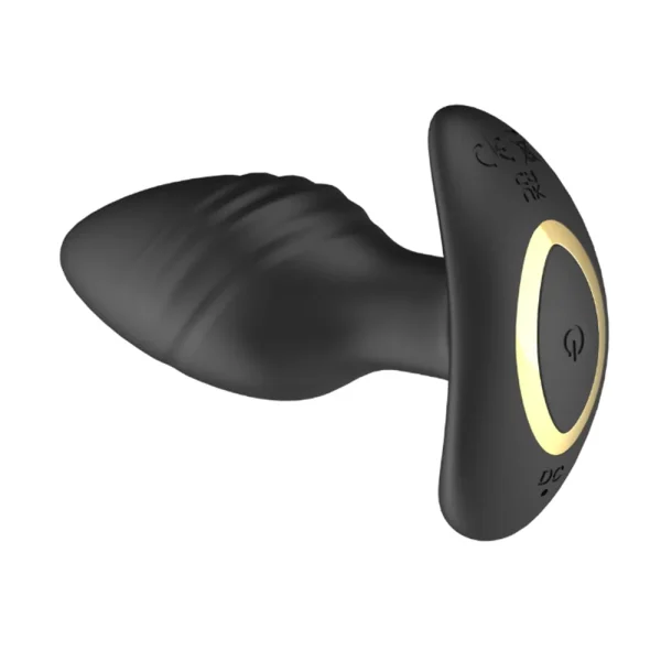 The Toosh Remote Controlled Silicone Rotating and Vibrating Butt Plug features a black textured silicone shaft, wide flared base with a gold accent ring, and an easy-access power button on the base of the toy.