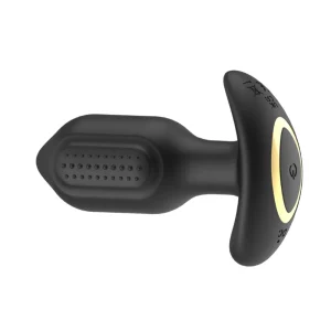 The Toosh Remote Controlled Silicone Vibrating Butt Plug is black with a dotted, textured surface, a T-shaped base, and features a gold-coloured power button.