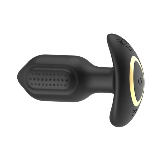The Toosh Remote Controlled Silicone Vibrating Butt Plug is black with a dotted, textured surface, a T-shaped base, and features a gold-coloured power button.