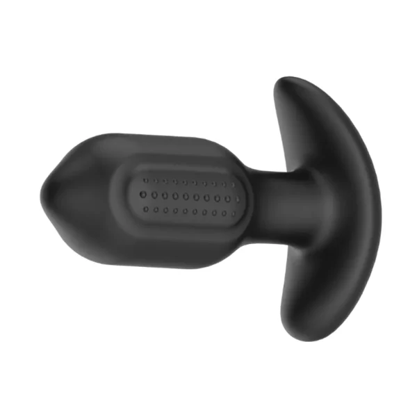 The Toosh Remote Controlled Silicone Vibrating Butt Plug is on its side, featuring a black textured surface on the side and a curved, wide base, is shown against a white background.