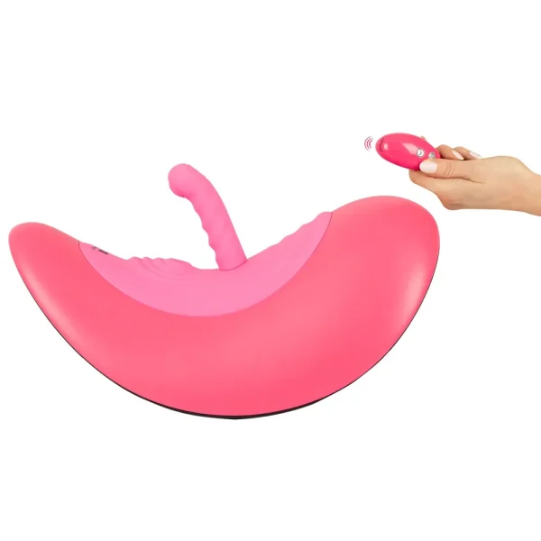 The VibePad Ride On is a pink, saddle-shaped adult vibrator with a dildo attachment, controlled remotely by hand.