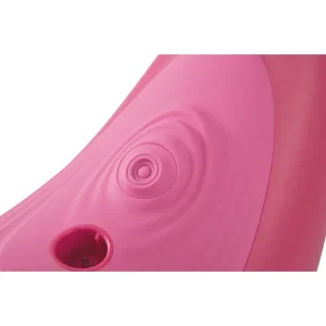 Close-up of the VibePad Ride On Vibrating Remote Control Saddle Vibrator, featuring a bright pink curved surface with a circular ripple pattern stimulator and a round opening for the attachments.