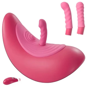 The VibePad Ride On Vibrating Remote Control Saddle Vibrator is a large pink rocker saddle with a central insertable attachment, textured surface, three interchangeable attachments, and a small wireless remote.