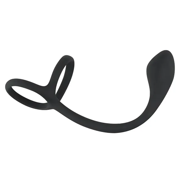 A black silicone cock and ball ring with attached anal plug.