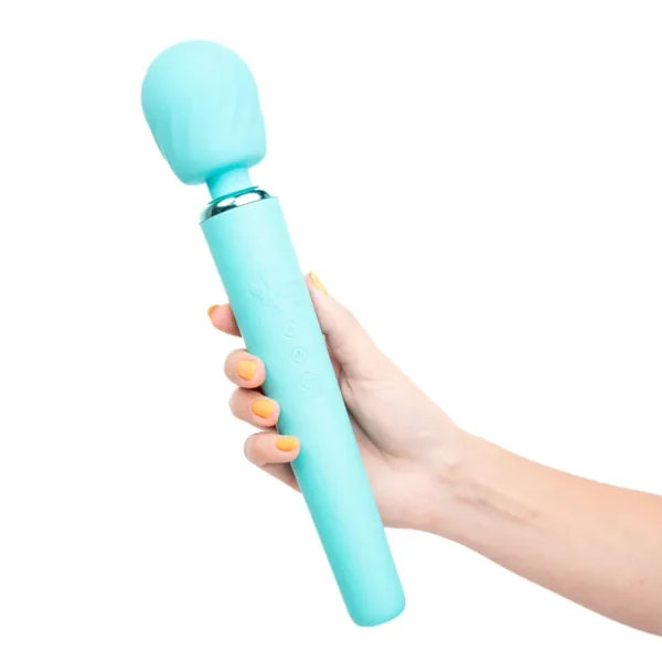 A hand with yellow-painted nails holds the Maia Toys Nala Rechargeable 10 Function Wand Vibrator, featuring a turquoise colour, rounded head, and button controls on the handle.