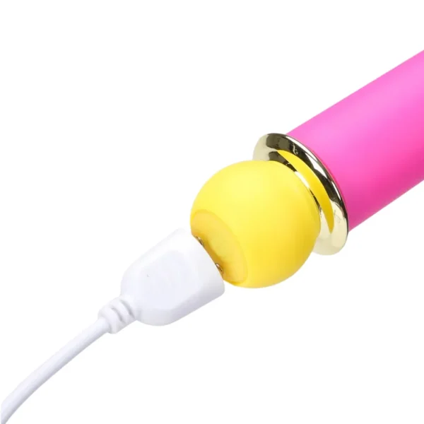 A close-up of the Maia Toys Rori Rechargeable 10 Function Bullet Vibrator, being charged via a white USB cable.