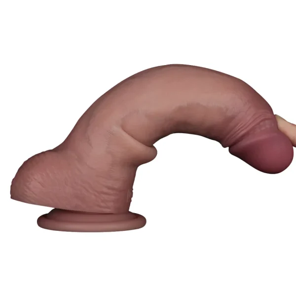 A finger bending the Sliding Skin Pro II Realistic 8.5 Inch Dual Layer Silicone Dildo, to show its flexibility.