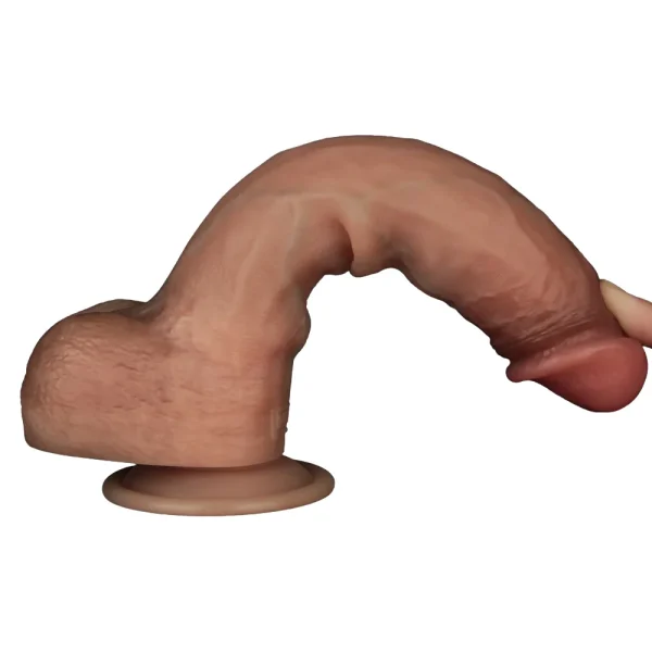 A close-up of a finger bending the Sliding Skin Pro Realistic 9 Inch Dual Layer Silicone Dildo, to show its flexibility.