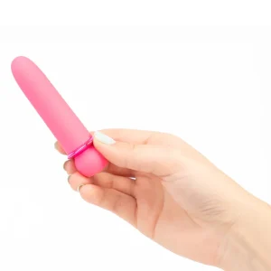 A hand holds the Maia Toys Jaguar Rechargeable 10 Function Bullet Vibrator, a small pink bullet vibrator, against a plain white background.