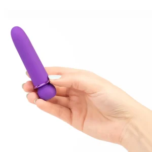 A hand holds the Maia Toys Jaguar Rechargeable 10 Function Bullet Vibrator, a small purple bullet vibrator, against a white background.