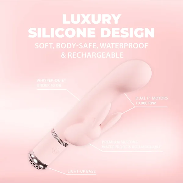 The Loveline Paris Collection Belle Rabbit Vibe, shown on a pink background, features luxury silicone, a light-up base, is body-safe, waterproof, rechargeable, has a quiet motor, and dual F1 motors with 10,000 RPM.