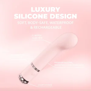 The Loveline Paris Collection Cherie G-Spot Vibe is a pale pink silicone G-spot vibrator with a curved tip, waterproof and rechargeable, body-safe silicone, light-up base, quiet motor under 50 dB, and 10,000 RPM speed on a soft pink background.