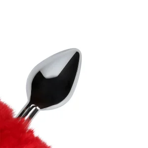 Close up of the Ouch Bunny Tail Metal Butt Plug is a shiny, teardrop-shaped metal plug featuring a red, fluffy tail at the base, shown against a plain white background.