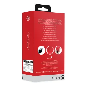 Back view of the Ouch Bunny Tail Metal Butt Plug red and white packaging with the brand logo at the bottom. The box displays images of a metal plug with a fluffy black tail, features in multiple languages, and a barcode.