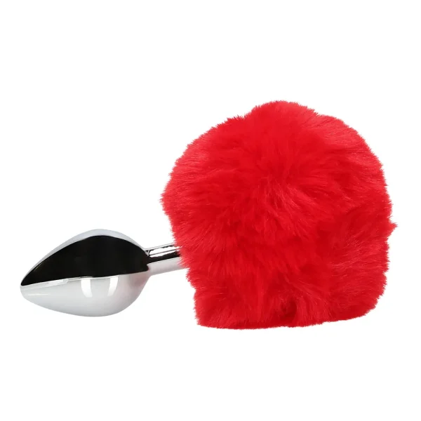 Side view of the Ouch Bunny Tail Metal Butt Plug, it features a silver metallic design with a large, bright red faux fur pom-pom bunny tail attached at the end, shown against a plain white background.