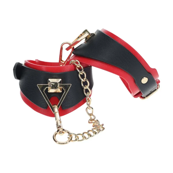 ouch-milan-collection-handcuffs The Ouch Milan Collection Handcuffs are black and red faux leather wrist cuffs, connected by a gold chain and metal clasps, perfect for restraint or bondage play.