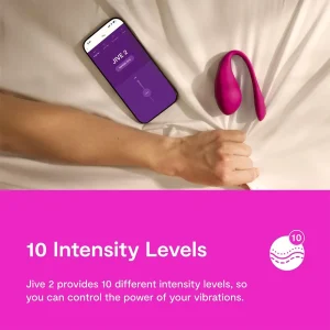 A hand rests on a bed near a smartphone showing a remote control app and the pink We-Vibe Jive 2 App Controlled Rechargeable Love Egg Vibrator, with text highlighting its 10 vibration intensity levels.