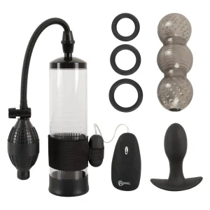 The Rebel 7-Piece Performance Sex Toy Set features a clear pump with black hose and bulb, three black cock rings, a textured transparent masturbator sleeve, remote control bullet, and black butt plug, all arranged on a white background.