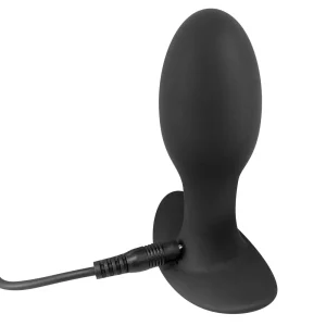 The Rebel 7-Piece Performance Sex Toy Set includes a black, silicone butt plug with a flared base, shown charging via cable at the base against a white background.