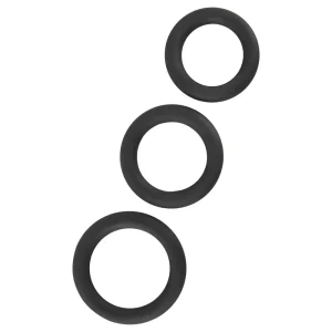 Three black cock rings of varying sizes from the Rebel 7-Piece Performance Sex Toy Set are arranged diagonally on a white background.