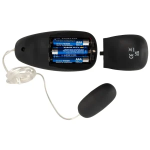 A black battery-powered Rebel 7-Piece Performance Sex Toy Set with its cover removed shows three AAA batteries inside, and a cord connects the main body to an attached vibro bullet.