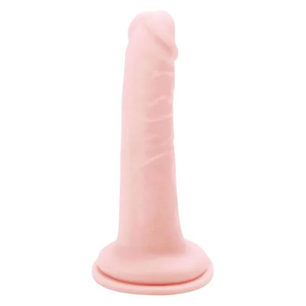 The Me You Us Ultra Cock 6.5 Inch Realistic Dildo, in a lifelike flesh tone dildo with a suction cup base, stands upright against a plain white background.
