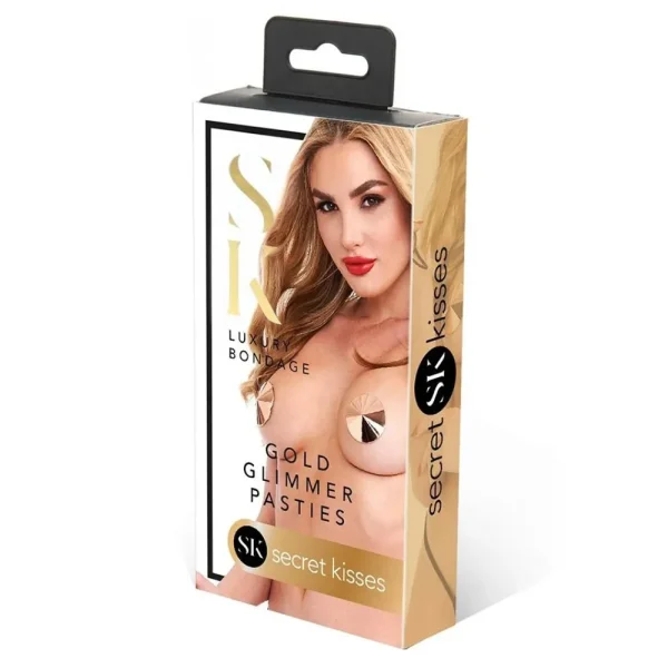 A retail package for Secret Kisses Rose Gold Glimmer Pasties, showing a woman wearing rose gold circular pasties. The box features a black hanging tab with gold, black, and white design accents.