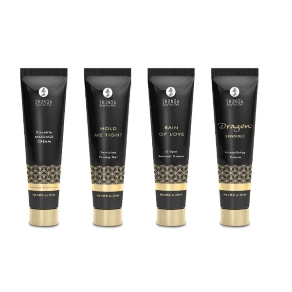 Four black and gold tubes from the Shunga Calendar of Desires are lined up, labeled: Kissable Massage Cream, Hold Me Tight Feminine Tightening Gel, Rain of Love G-Spot Arousal Cream, and Dragon Sensitizing Cream.