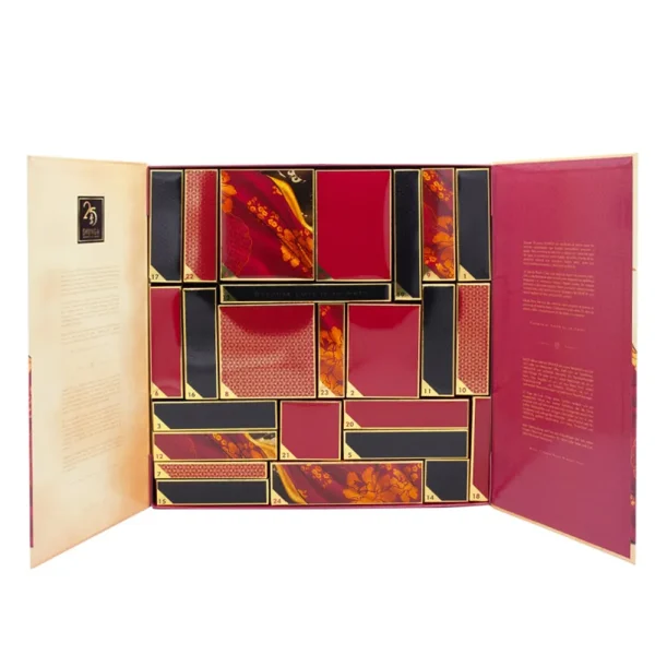 The Shunga Calendar of Desires is a luxury advent calendar with elegant red, black, and gold rectangular compartments featuring floral designs and individually numbered sections inside.