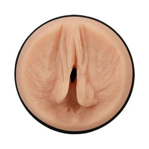 Close-up of the Doc Johnson Main Squeeze Kiley Corrupt UltraSkyn Stroker, featuring a realistic light skin tone vulva-shaped opening with detailed labia in a circular black-rimmed case, displayed on a white background.