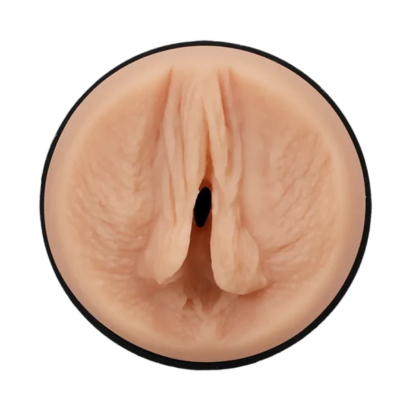 Close-up of the Doc Johnson Main Squeeze Kiley Corrupt UltraSkyn Stroker, featuring a realistic light skin tone vulva-shaped opening with detailed labia in a circular black-rimmed case, displayed on a white background.