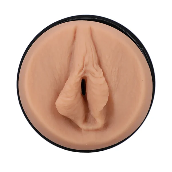 The Doc Johnson Main Squeeze Nicole Doshi UltraSkyn Stroker is a male masturbator with a realistic vulva-shaped opening in a black circular casing, shown on a white background.