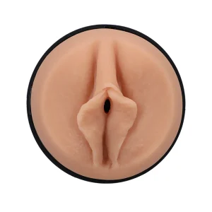 Close-up of the Doc Johnson Main Squeeze Stella Barey UltraSkyn Stroker’s realistic vulva-shaped opening, crafted in flesh-toned soft material with detailed labia, set in a circular black plastic housing.