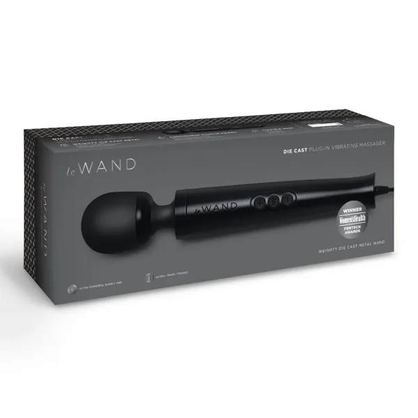 A boxed Le Wand Diecast Plug In Vibrating Wand Massager in black, featuring product images, details, and a "Winner: Women's Health" award badge on the packaging.