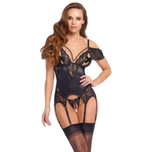 A woman poses in the Cottelli Lingerie Basque and Crotchless String Set, featuring black lace with suspender straps attached to thigh-high stockings. She has long wavy hair and stands against a white background.